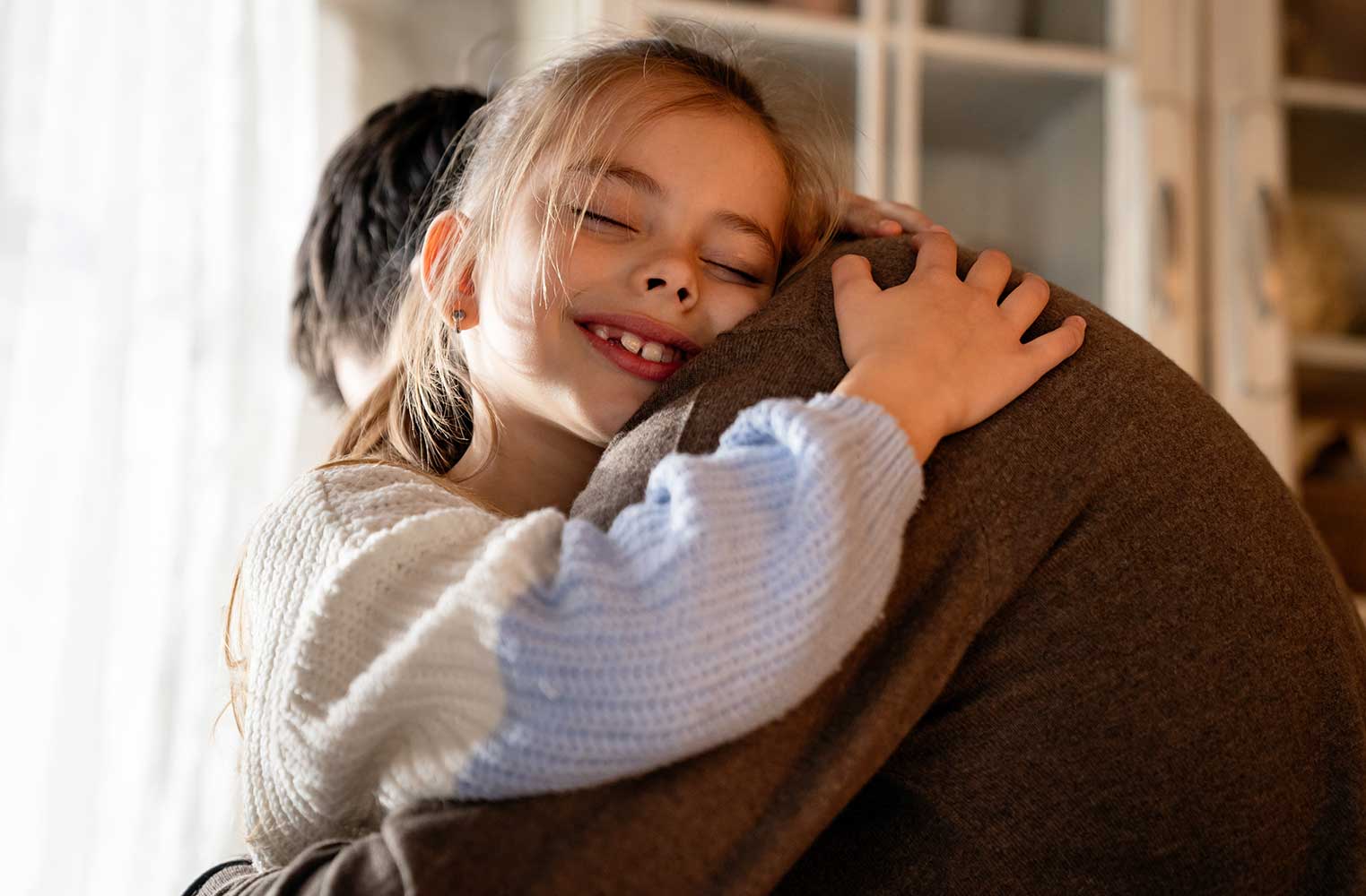 Young Girl Smiling And Embracing Her Father